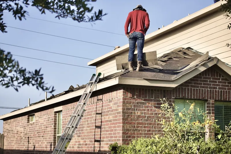 Professional roofer working on a residential roof in Babcock North